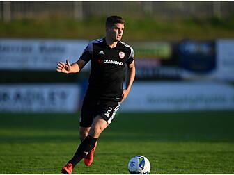 Defender Colm Horgan signs for...